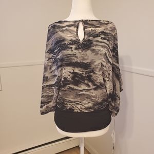 Jennifer Lopez layered top with keyhole closure